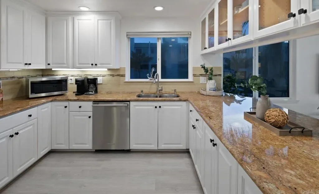 Kitchen with granite counters, stainless appliances and ocean-side windows