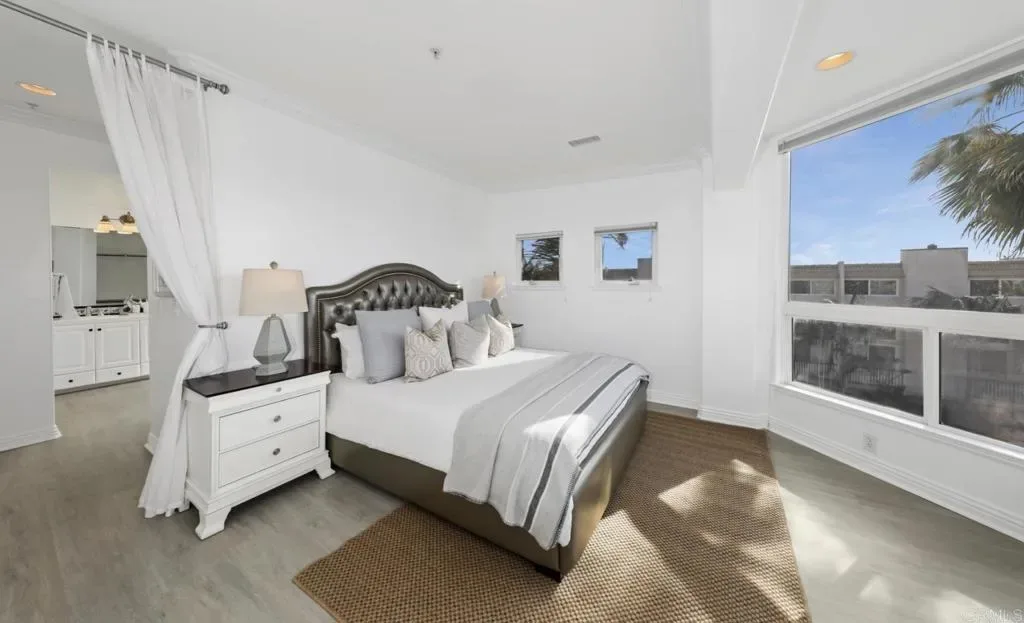 Bedroom with curtained entry to its private bathroom