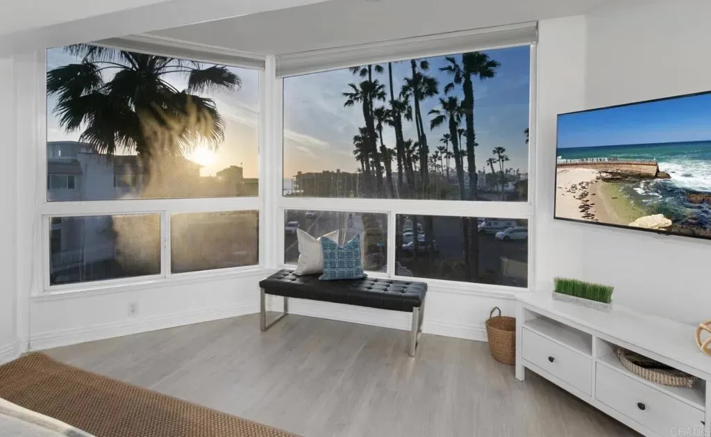 Primary bedroom with sun setting behind the palms