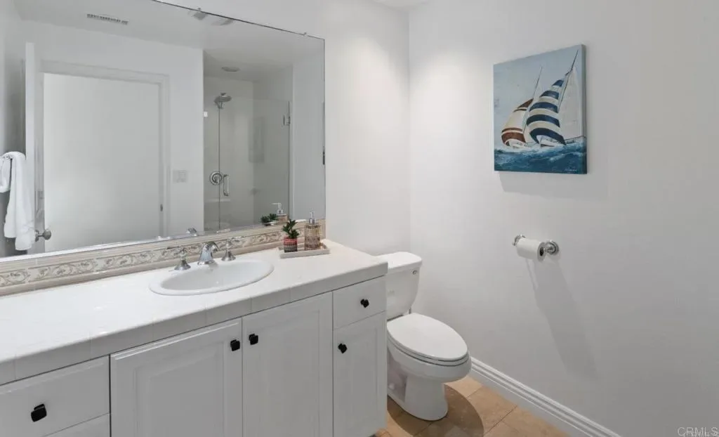 Full bathroom with tiled vanity and walk-in shower