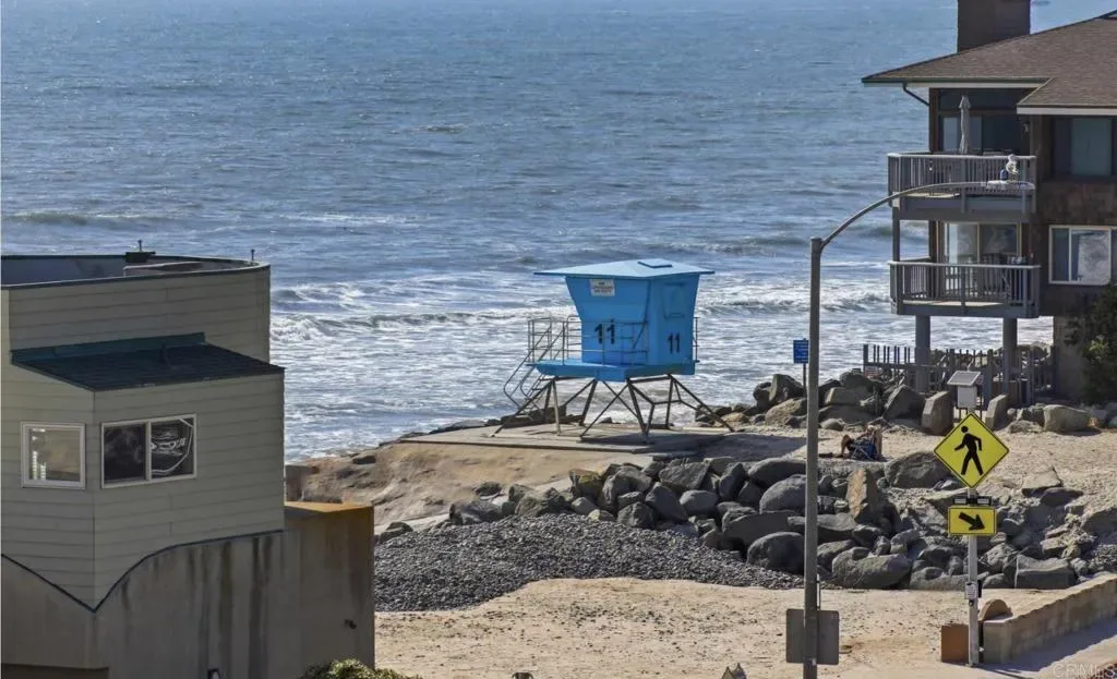 Lifeguard tower and cobbles on the beach a few steps from the door