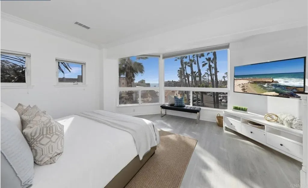 Second bedroom with vaulted ceiling and ocean-side windows