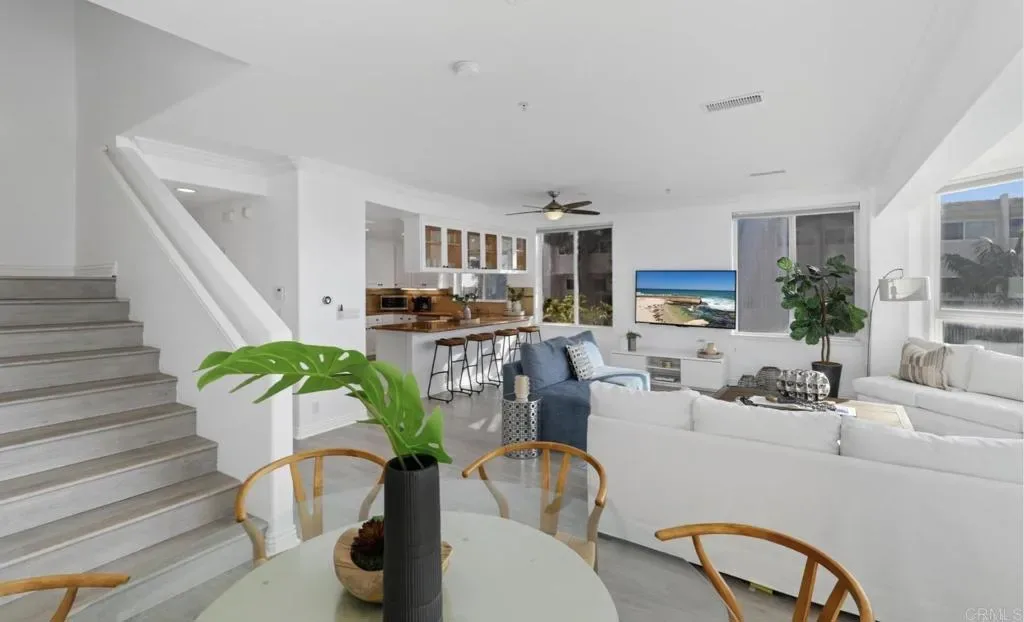 Stairs rising from the dining area to the upper floors