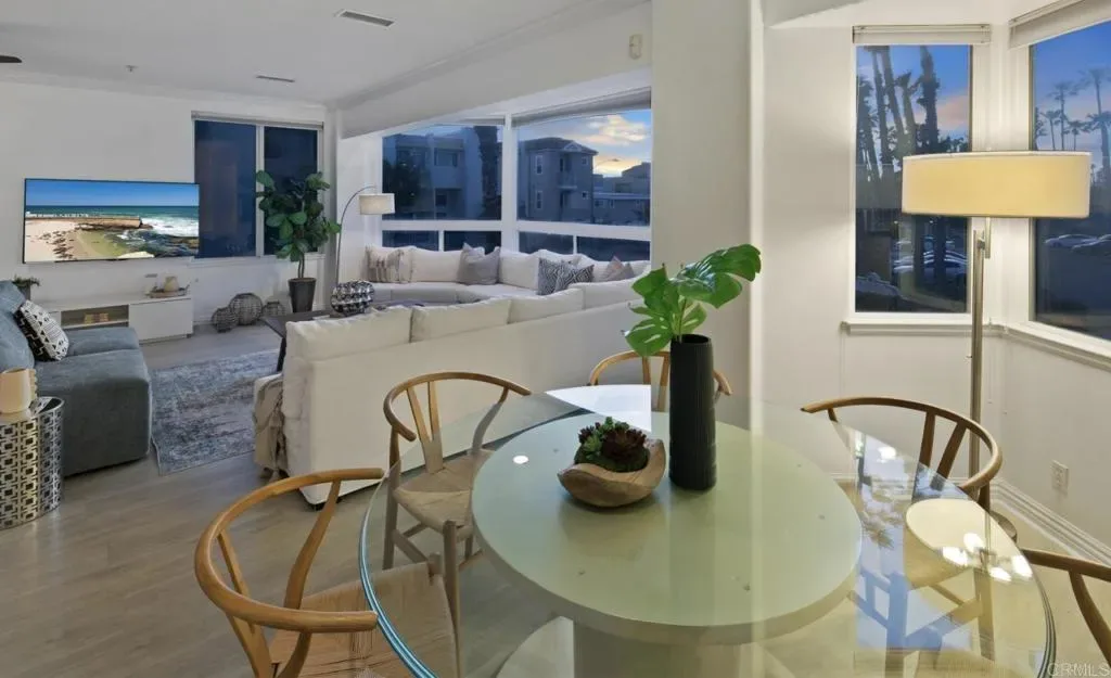 Dining table for four beside the living room windows