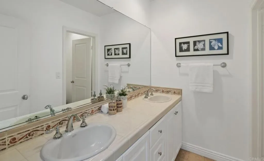 Double-vanity bathroom with framed mirror wall